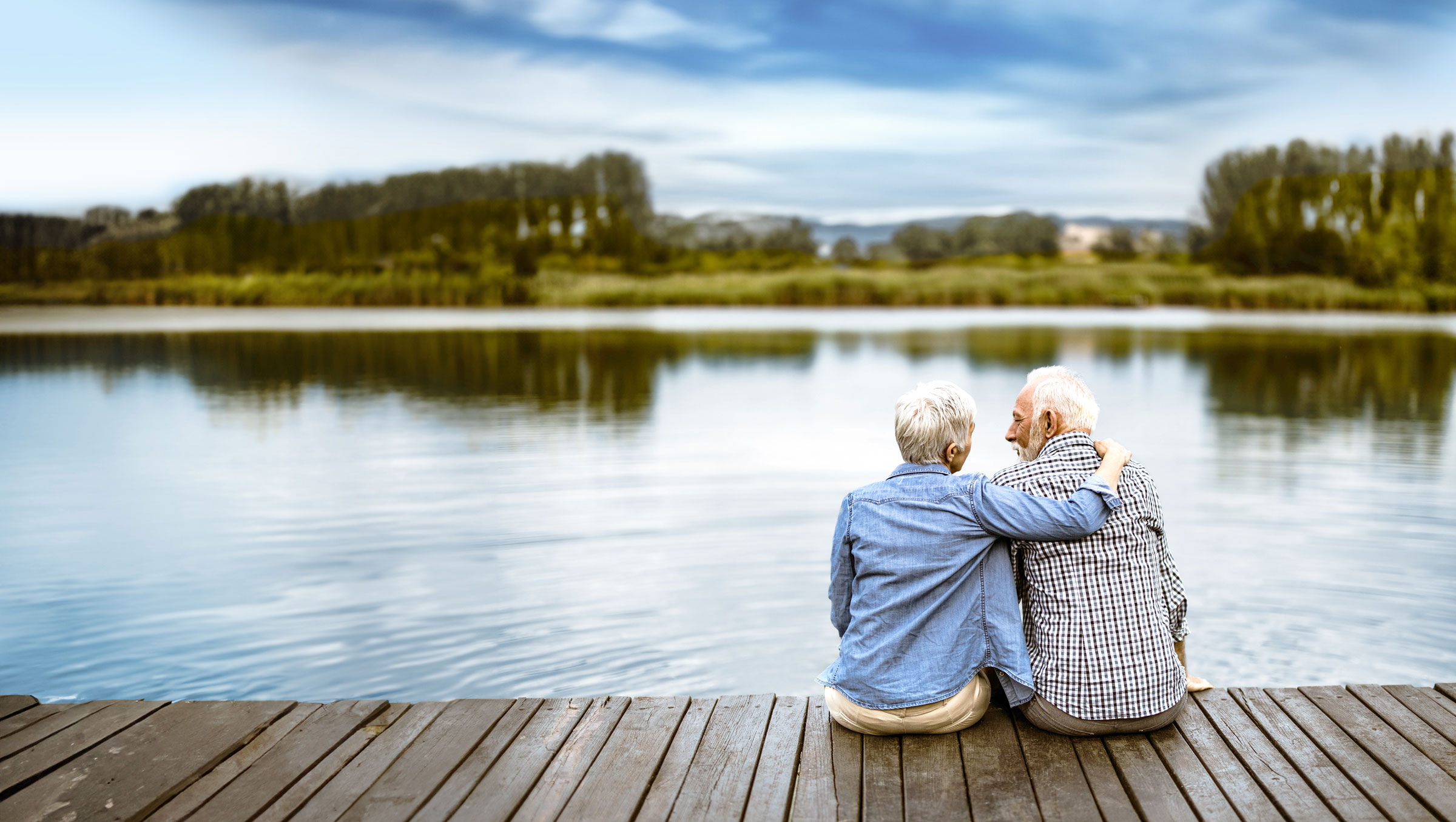 Senior Couple Sitting At Lake