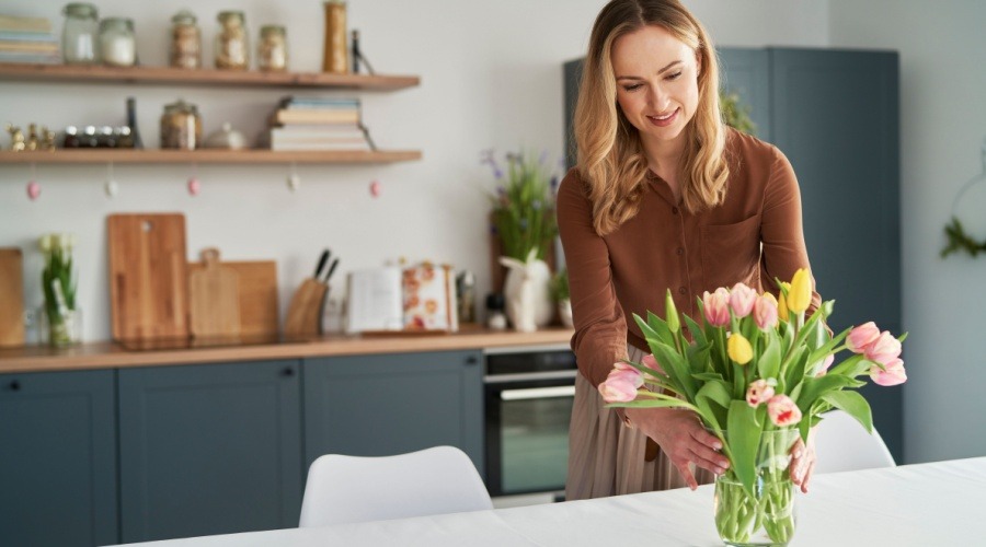 Women Putting Flowers Into Vase